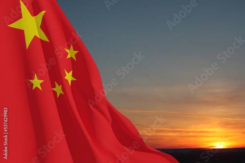 Foto Close up waving flag of China on background of sunset sky