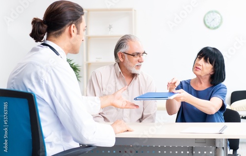 Old couple visiting young male doctor © Elnur