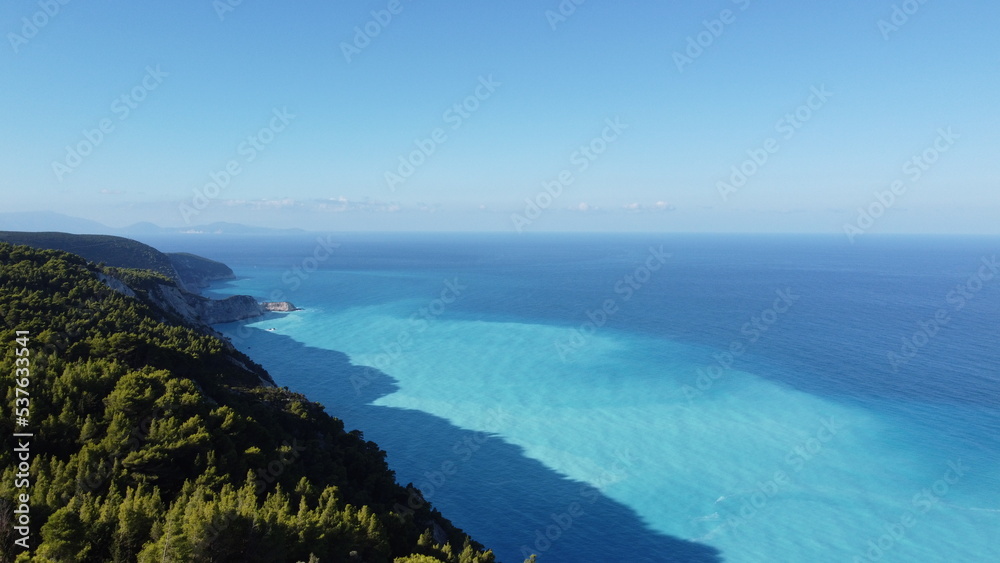 Fototapeta premium The beautiful turquoise blue color of the Ionian Sea that surrounds the Greek island of Lefkada and Potro Katsiki beach