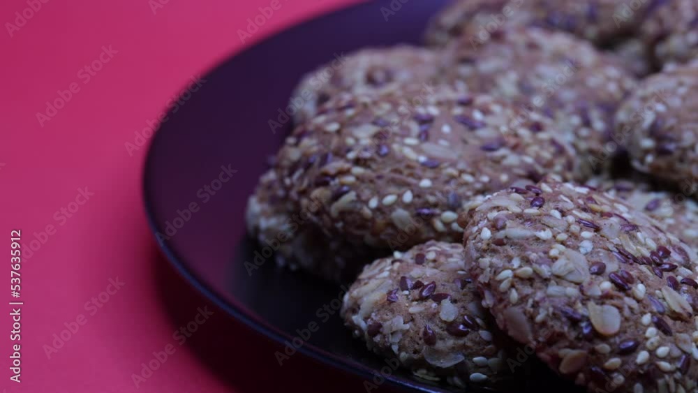 Freshly Baked Cookies On A White Porcelain Plate On A Red Background. Panning Dolly Slider Shot. 60 FPS, 4k, ProRes Freshly Baked Cookies On A White Porcelain Plate On A Red Background. Panning Dolly Slider Shot. 60 FPS, 4k, ProRes