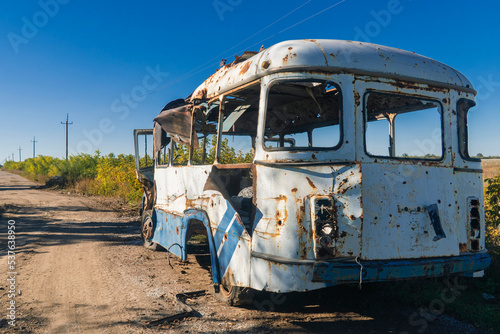 War in Ukraine. 2022 Russian invasion of Ukraine. Countryside. Damaged bus after shelling. Terror of the civilian population. war crime © Oleksandr Baranov