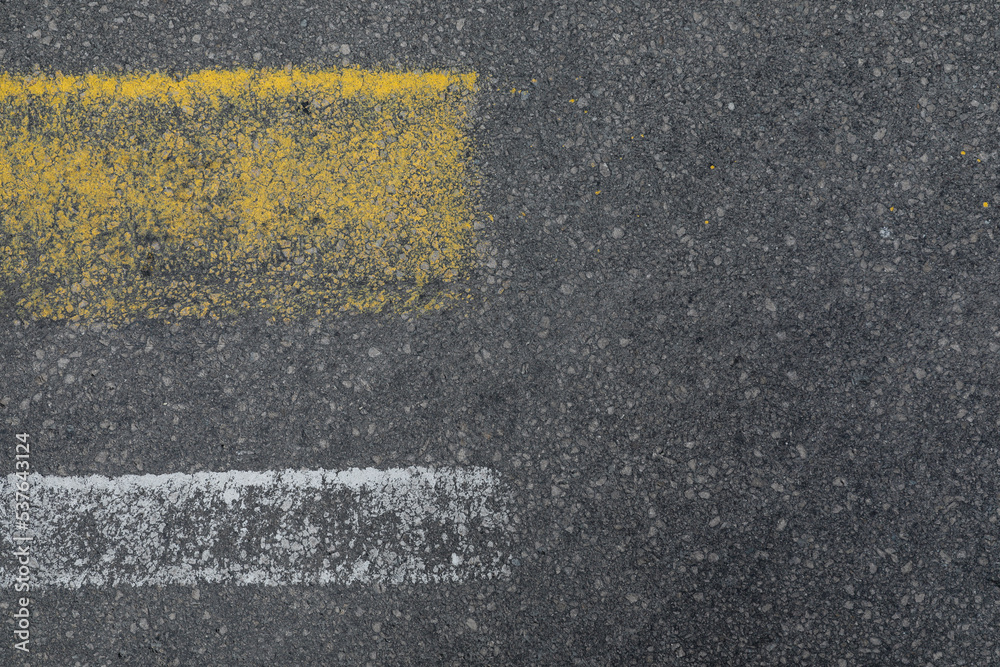 Fototapeta premium Grey asphalt road with white and yellow lines, space for text, no person