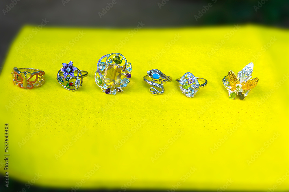 Sterling silver rings on yellow background