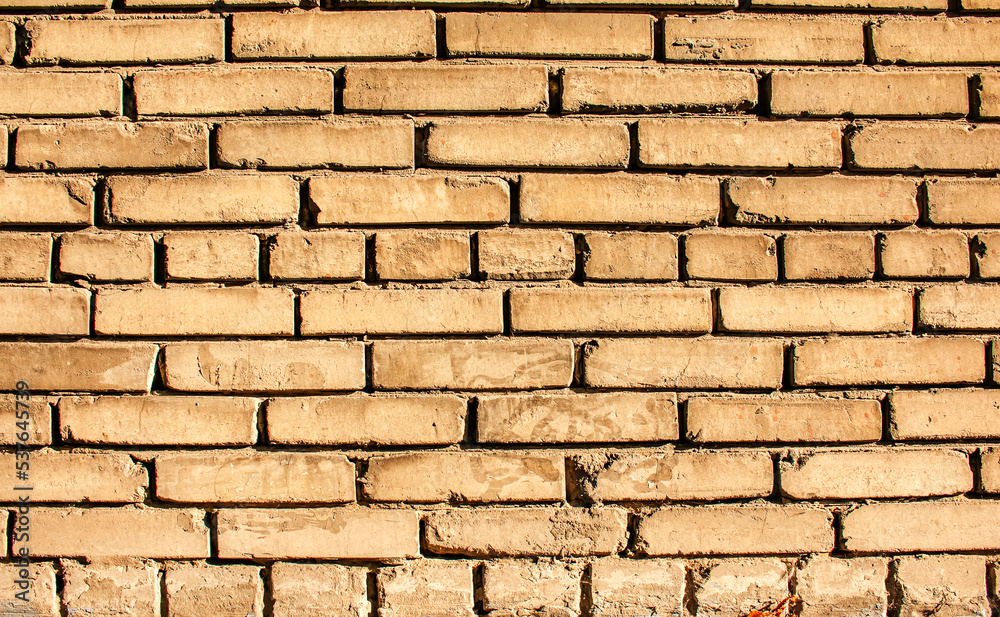 Obraz premium Old brick wall background, brick wall texture, structure. old broken brick, cement joints, close-up. Construction, repair. Concept of devastation, decline.