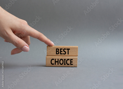Best choice symbol. Wooden blocks with words Best choice. Beautiful grey background. Businessman hand. Business and Best choice concept. Copy space.