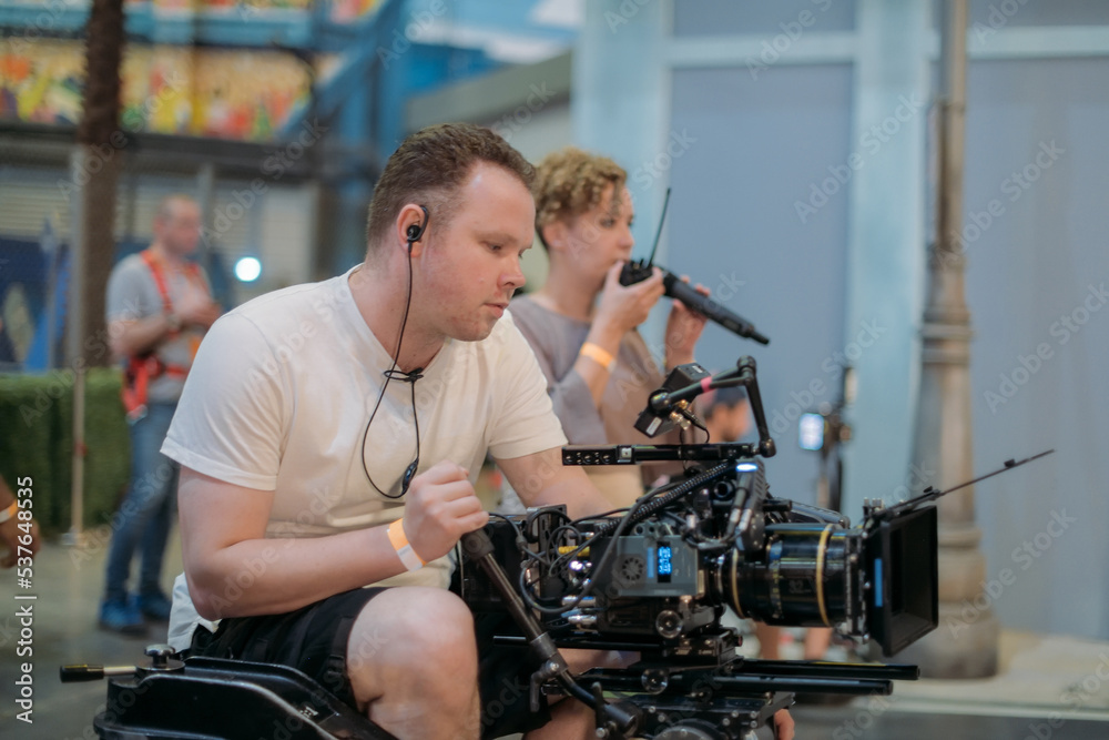 Director of photography with a camera in his hands on the set. Professional videographer at work on filming a movie Director of photography with a camera in his hands on the set. Professional videographer at work on filming a movie