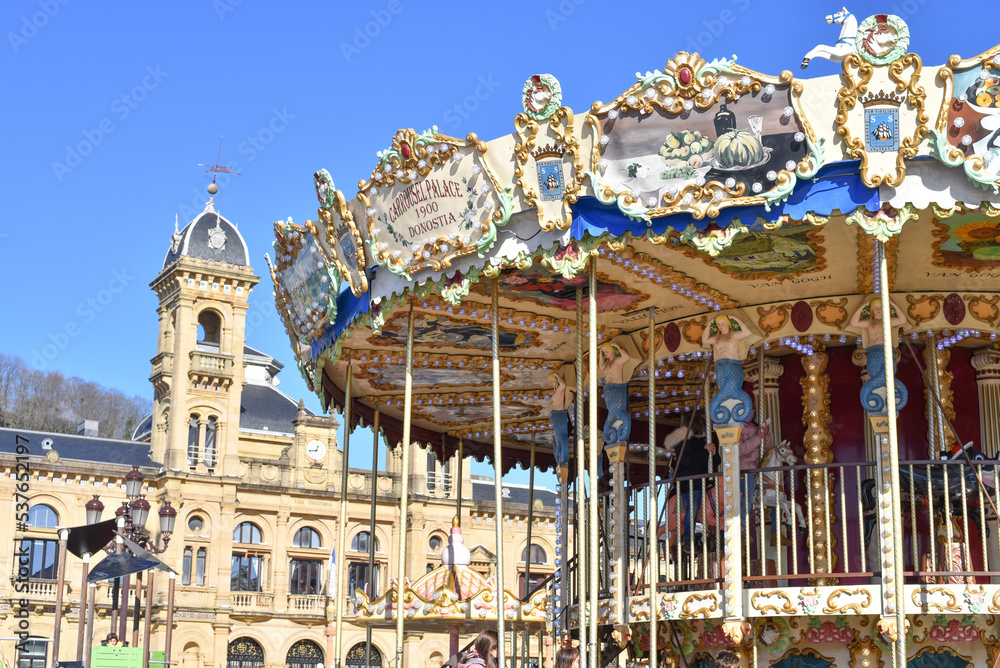 Fototapeta premium San Sebastian, Spain - 22 Jan, 2022: City hall & merry-go-round on La Concha promenade