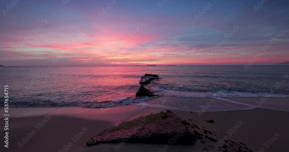 Dramatic sea sunrise over lonely island beach