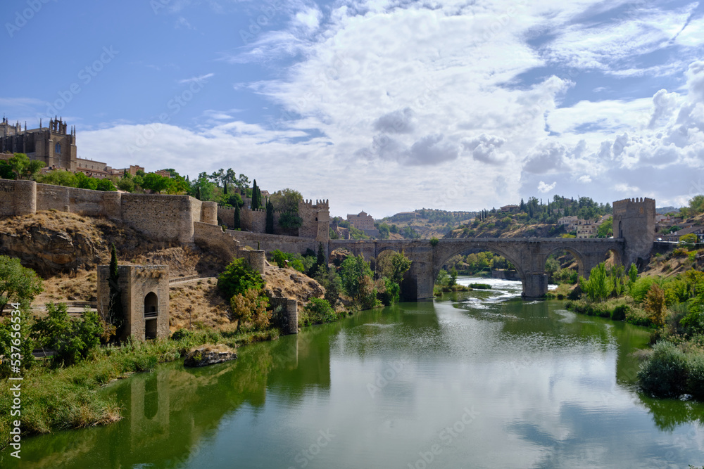 View of the San Martin's Bridge and the Tagus River in Toledo, Spain. It is a scenic 14th-century pedestrian bridge.
