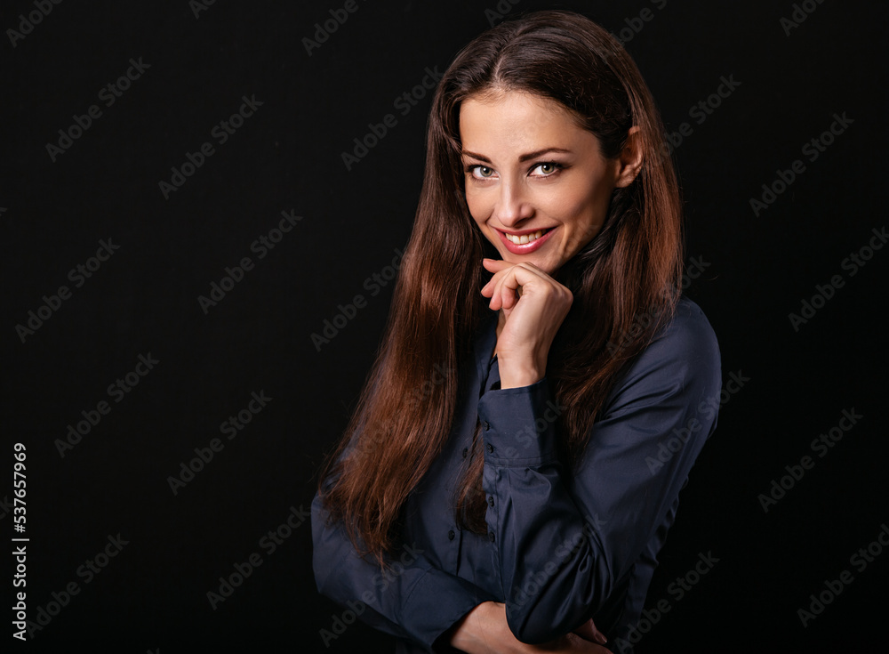 Beautiful thinking toothy smiling business woman with folded arms in blue shirt on black background with empty copy space for text. Closeup