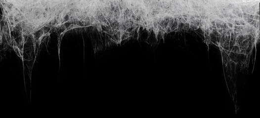 Creepy hanging spider web or cobweb on black, top border. Spooky Halloween or gothic background.