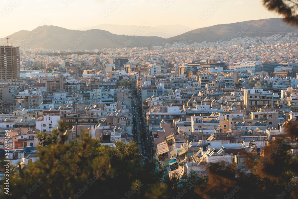 Obraz premium Piraeus city, Attica, beautiful panoramic view of Piraeus, Greece, with harbour and port, mountains and scenery beyond the city, seen from Prophet Helias Hill on Kastela Hill, sunset summer view