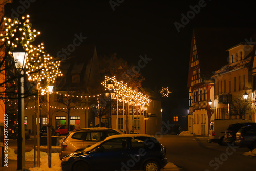 Christmas illumination in Germany. half timbered houses and festive decorations.Christmas in Europe.Decorative yellow flashlight and shimmering garland on a black background. 