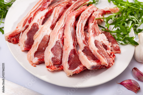 Fresh raw lamb ribs for chops with garlic and herbs. Ingredients for cooking delicious dishes