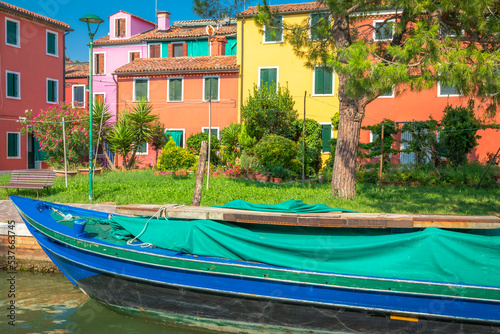Burano island canal, colorful houses and boats, Venetian lagoon, Italy