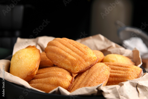 Delicious madeleine cakes in bowl, closeup view