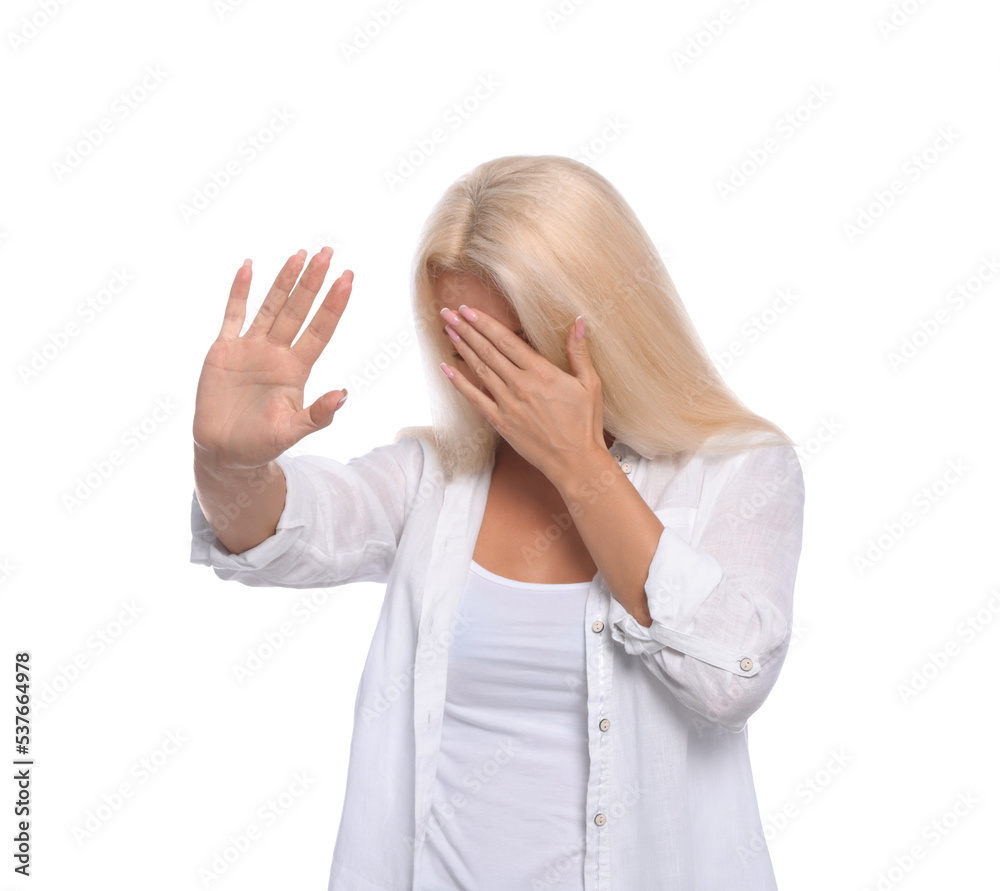 Embarrassed woman covering face with hand on white background Embarrassed woman covering face with hand on white background