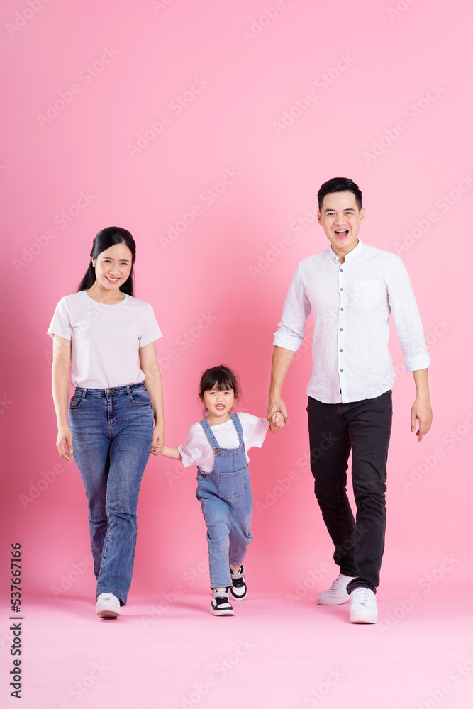 happy young asian family image, isolated on pink background happy young asian family image, isolated on pink background