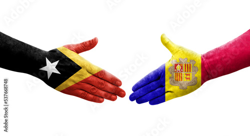Handshake between Andorra and Timor Leste flags painted on hands, isolated transparent image.