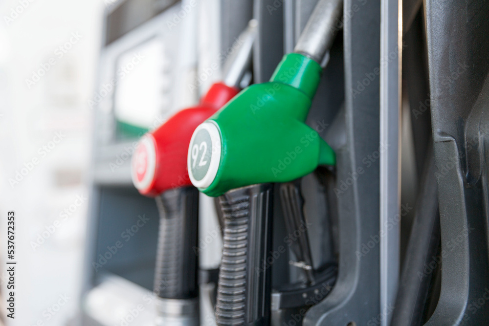 Pistols for refueling gasoline at a gas station. Close-up. Vertical. Fuel and energy crisis. Pistols for refueling gasoline at a gas station. Close-up. Vertical. Fuel and energy crisis.