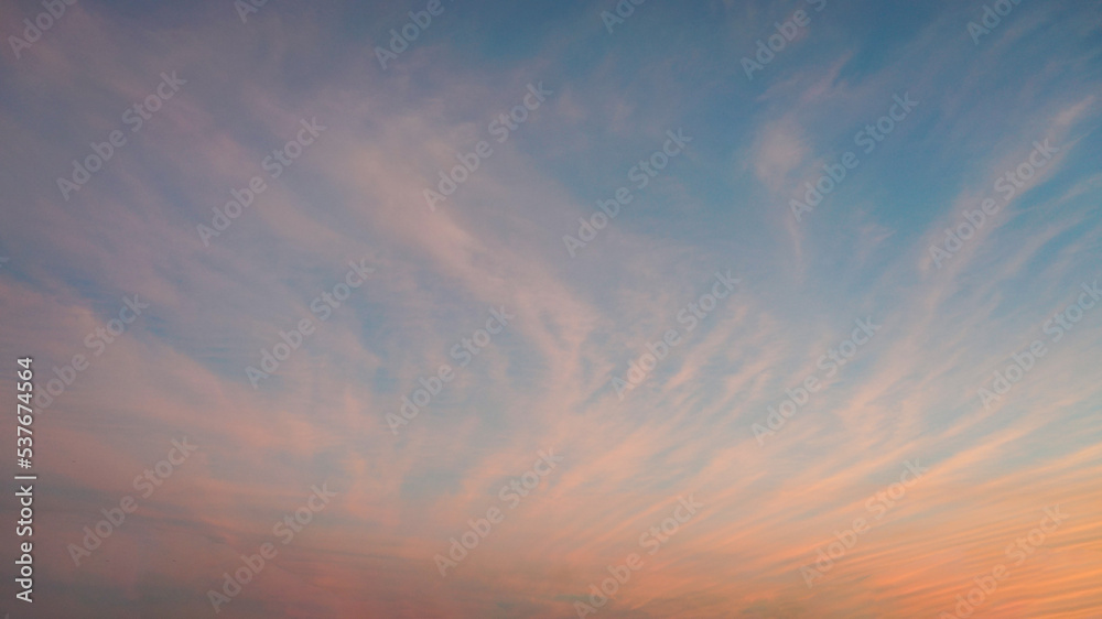 Fine wispy pale salmon pink clouds at sunset