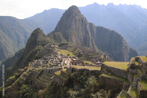 Machu Picchu is a 15th-century Inca citadel located in  southern Peru on a 2,430-meter (7,970 ft) mountain ridge. It is located within Urubamba Province above the Sacred Valley, northwest of Cusco.