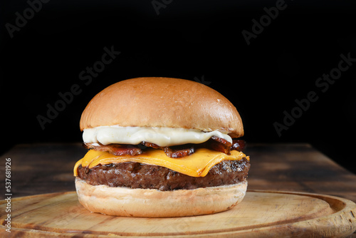 tasty hamburger sandwich with tomato onion salad and bread isolated on black background