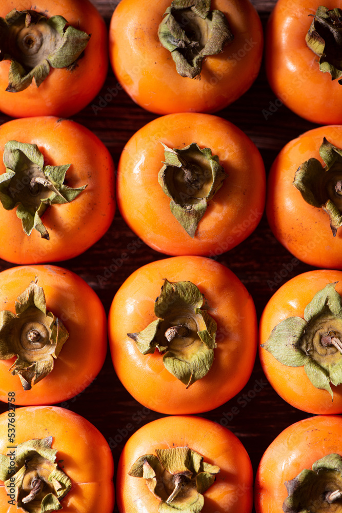 row of Ripe persimmon fruit background.Close up of fresh kaki row of Ripe persimmon fruit background.Close up of fresh kaki
