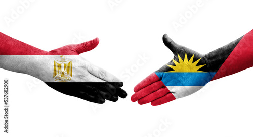 Handshake between Antigua and Barbuda and Egypt flags painted on hands, isolated transparent image.