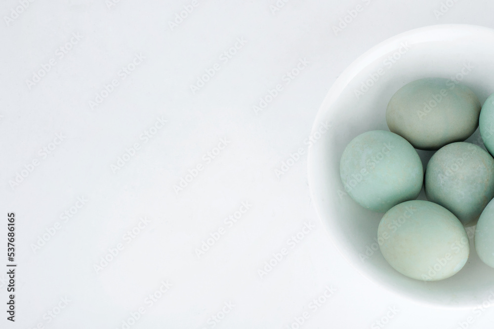 duck egg is in a white bowl on white background duck egg is in a white bowl on white background
