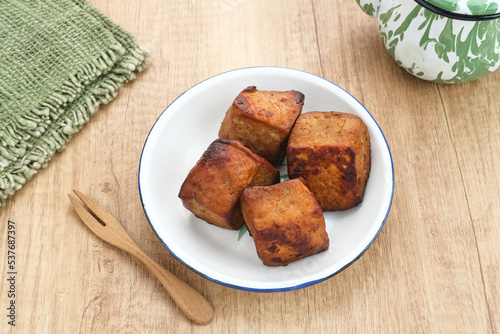 Tahu Bacem, traditional food from Central Java, Indonesia, cooked with spices, palm sugar and coconut water. Boil, then fry briefly.
 photo