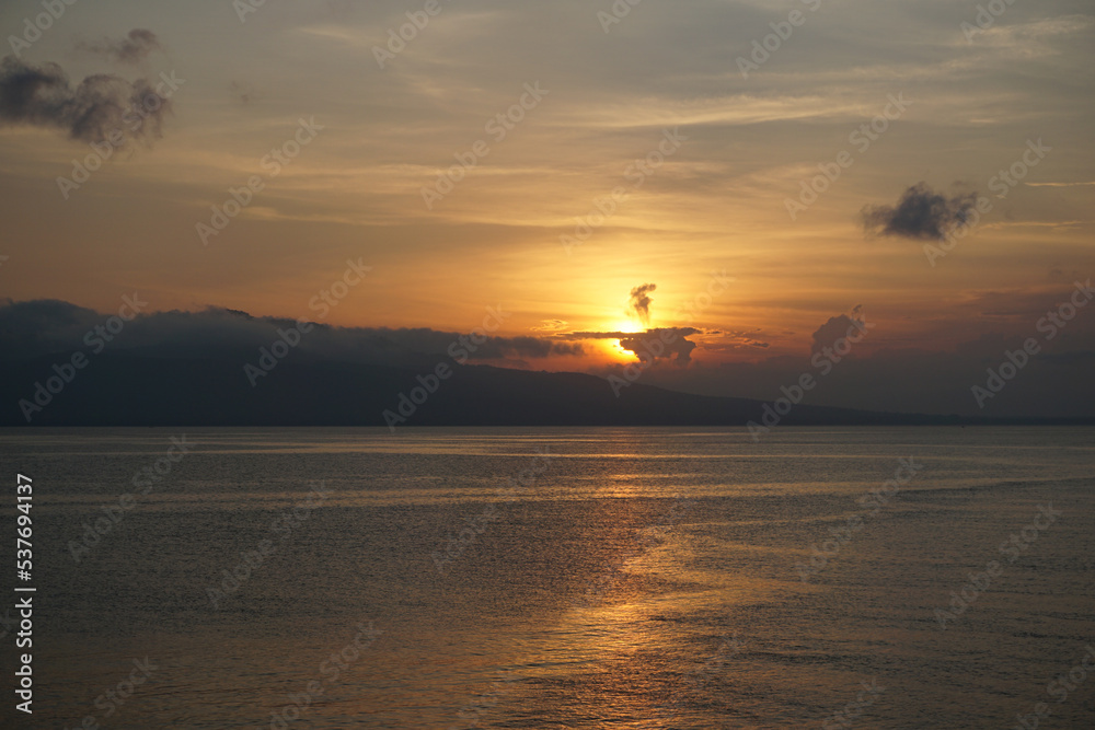 Beautiful sunrise and dramatic sky at the beach in Banyuwangi, East Java, Indonesia.