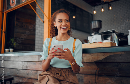 Phone, social media and coffee shop with a woman customer thinking of an idea while sitting at a counter in a cafe. Mobile, internet and communication with a young female sitting in a restaurant