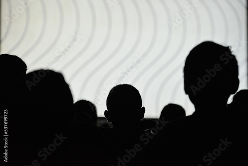 Silhouette of people watching a movie during an itinerant film exhibition on the banks of the Guaporé-Itenez river, Versalles, Beni Department, Bolivia, on the border with Rondonia state, Brazil
