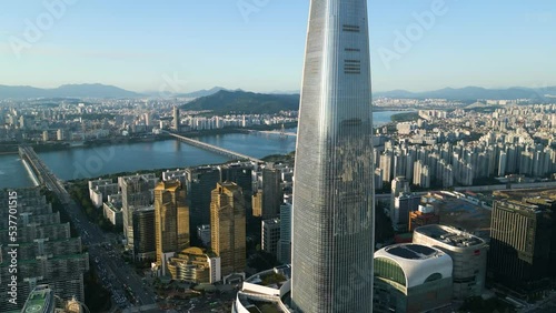 Drone Shot of Lotte World at sunset with a city view and Han River in the background, Seoul, South Korea photo