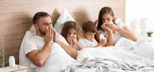 Family ill with flu in bed ...