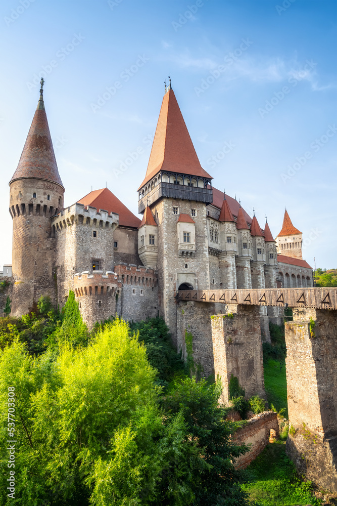 Summer view with Corvin castle with bridge over a small river in a sunny day in Romania