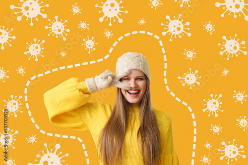 Happy young woman and drawn virus on orange background. Concept of strong immunity