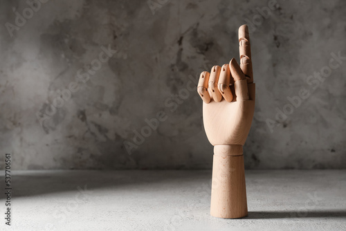 Wooden hand with raised ind...