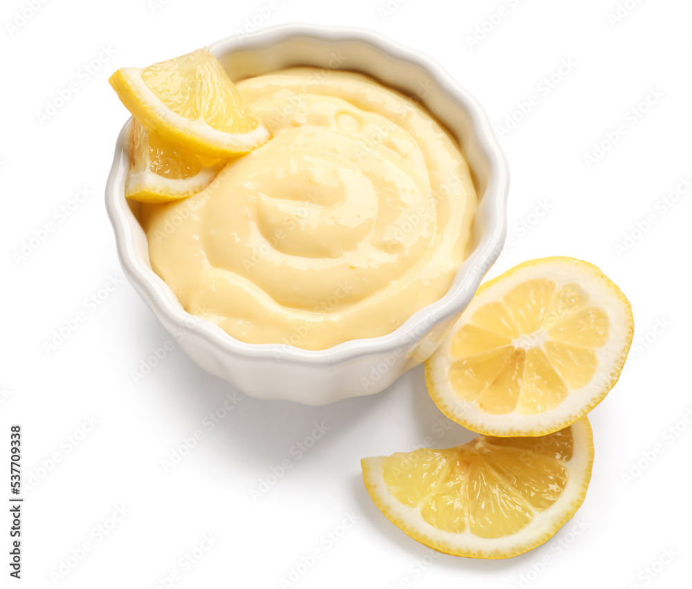 Ramekin of delicious vanilla pudding and lemon on white background Ramekin of delicious vanilla pudding and lemon on white background