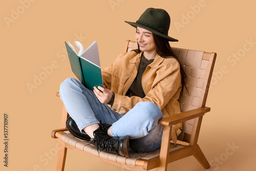 Young woman reading book in...