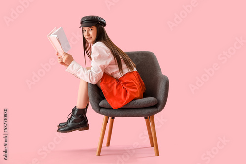 Stylish young woman reading...
