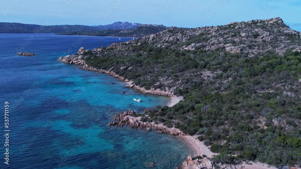 Birds eye view of the majestic cliffs beside coastline of beach and low tides moving towards them. Birds eye view of the majestic cliffs beside coastline of beach and low tides moving towards them.