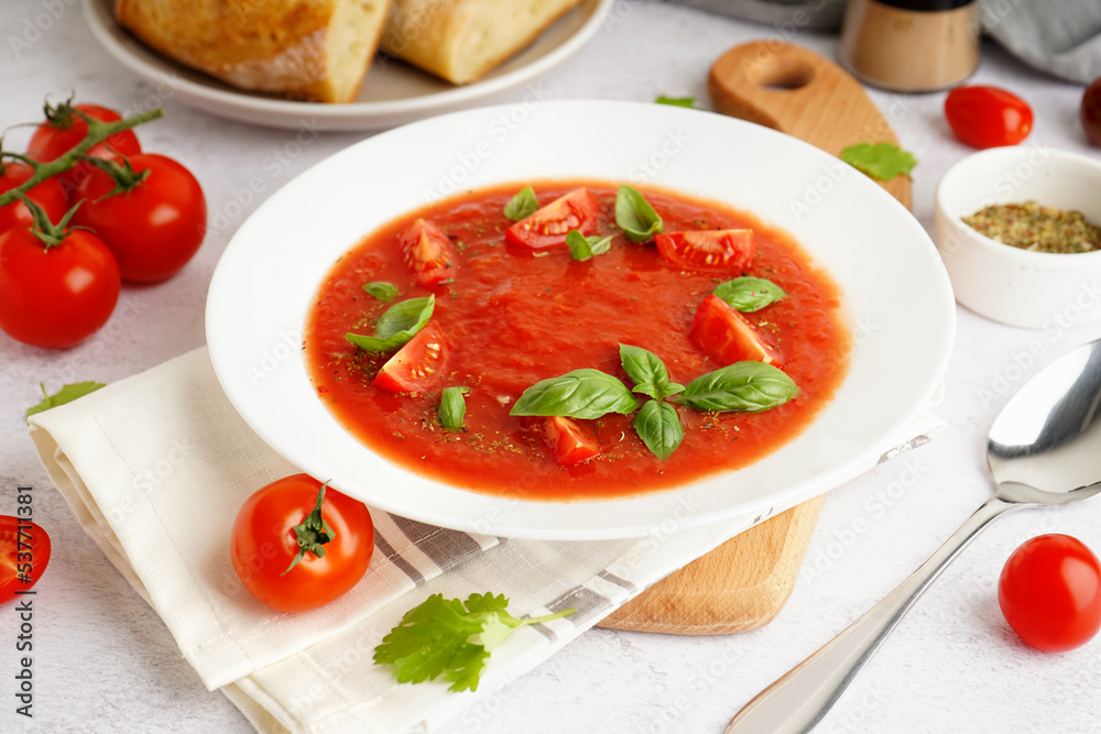 Plate with delicious tomato soup on light background Plate with delicious tomato soup on light background