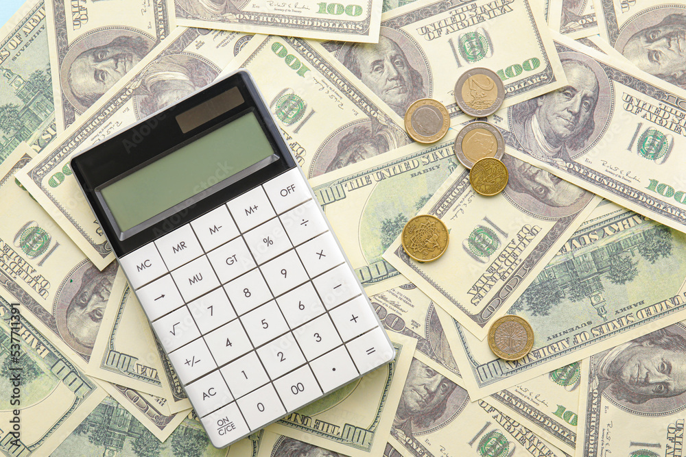Calculator and cents on dollar banknotes. Exchange rate concept Calculator and cents on dollar banknotes. Exchange rate concept