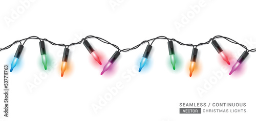 Christmas seamless lights vector design. Seamless sparkling xmas light with hanging colorful glowing bulb isolated in white background. Vector Illustration.