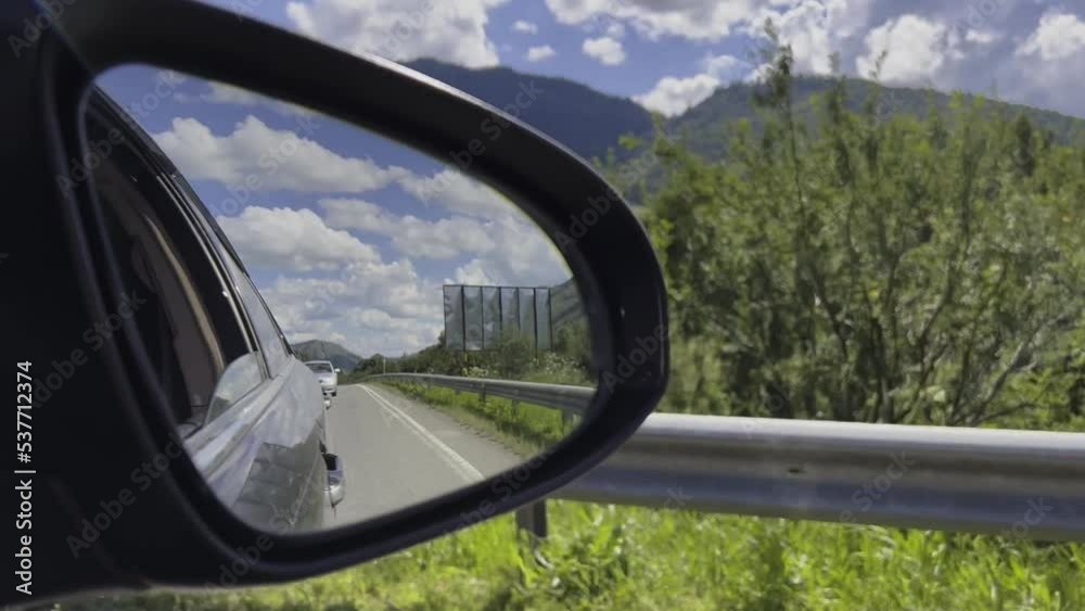 Reflection of the highway in the side mirror of the car. High quality 4k footage