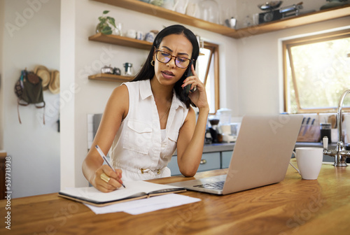 Business woman, professional and entrepreneur on phone call talking while working remote on laptop in home. Freelancer answering to chat, network and consulting while planning notes