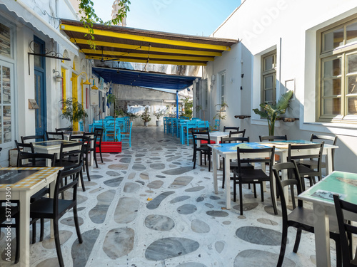 Greek outdoors tavern restaurant with awning at Tinos island, Chora town, Cyclades Greece.
