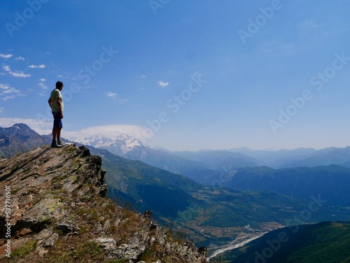 Man hiking at Koruldi lakes. Hiker enjoying beautiful view of Great Caucasus mountains close to Mestia in Upper Svaneti  Georgia.